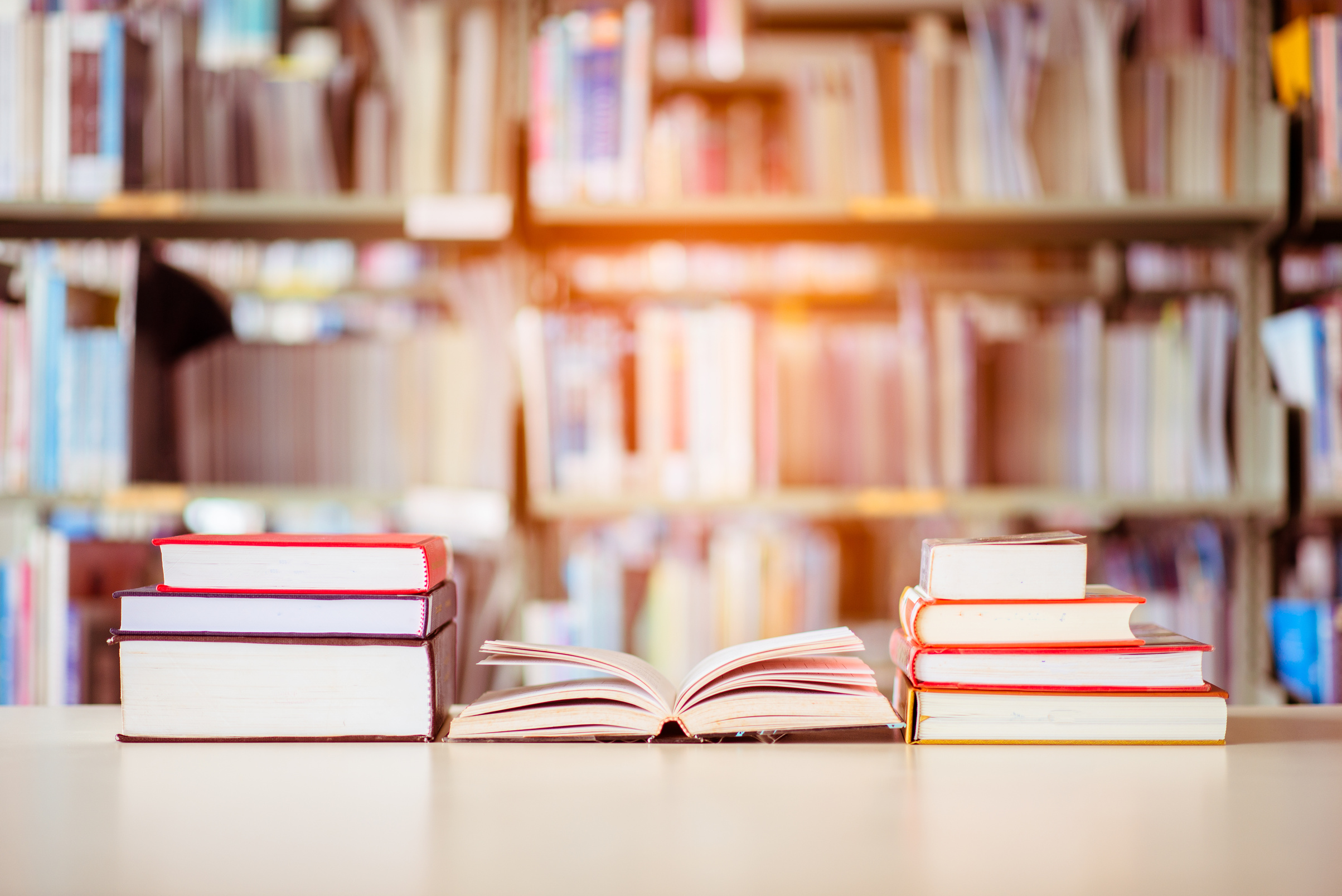 Book stack is placed on the library desk. education background, back to school concept.